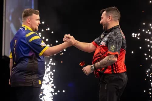 Luke Littler (L) shakes the hand of Johnny Clayton (R). Pic. Alamy