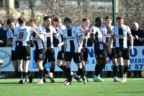 Flint Town United players celebrate on their way to a 5-1 victory over Bangor City. Pic: FAW